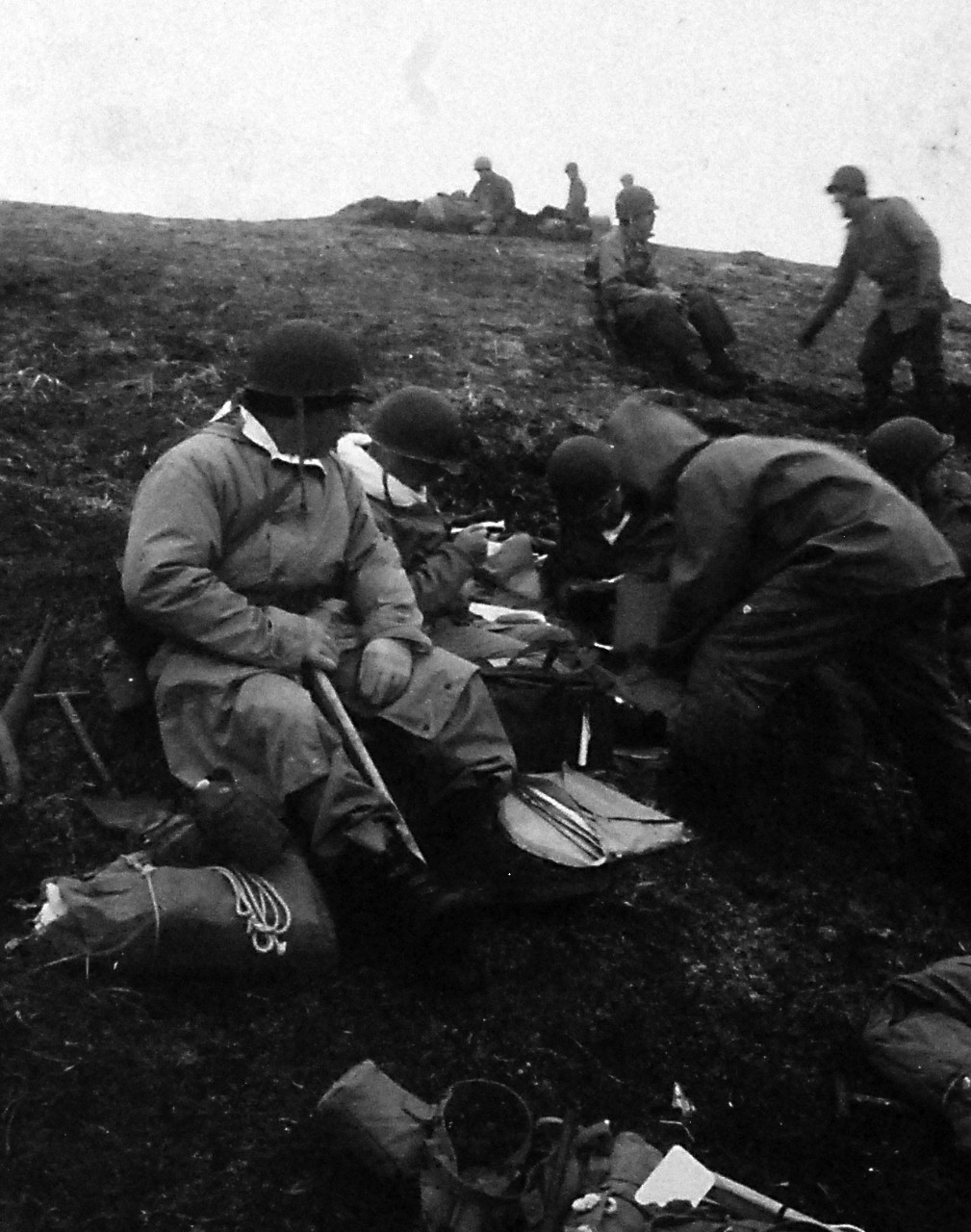 80-G-50933:    Aleutian Islands Campaign, June 1942 - August 1943.  Battle for Attu, May 1943.    U.S. Occupation of Attu, Aleutian Islands.  Intelligence men (G-2) looking over captured Japanese articles, May 13, 1943.  U.S. Navy Photograph, now in the collections of the National Archives.  (2016/05/10).