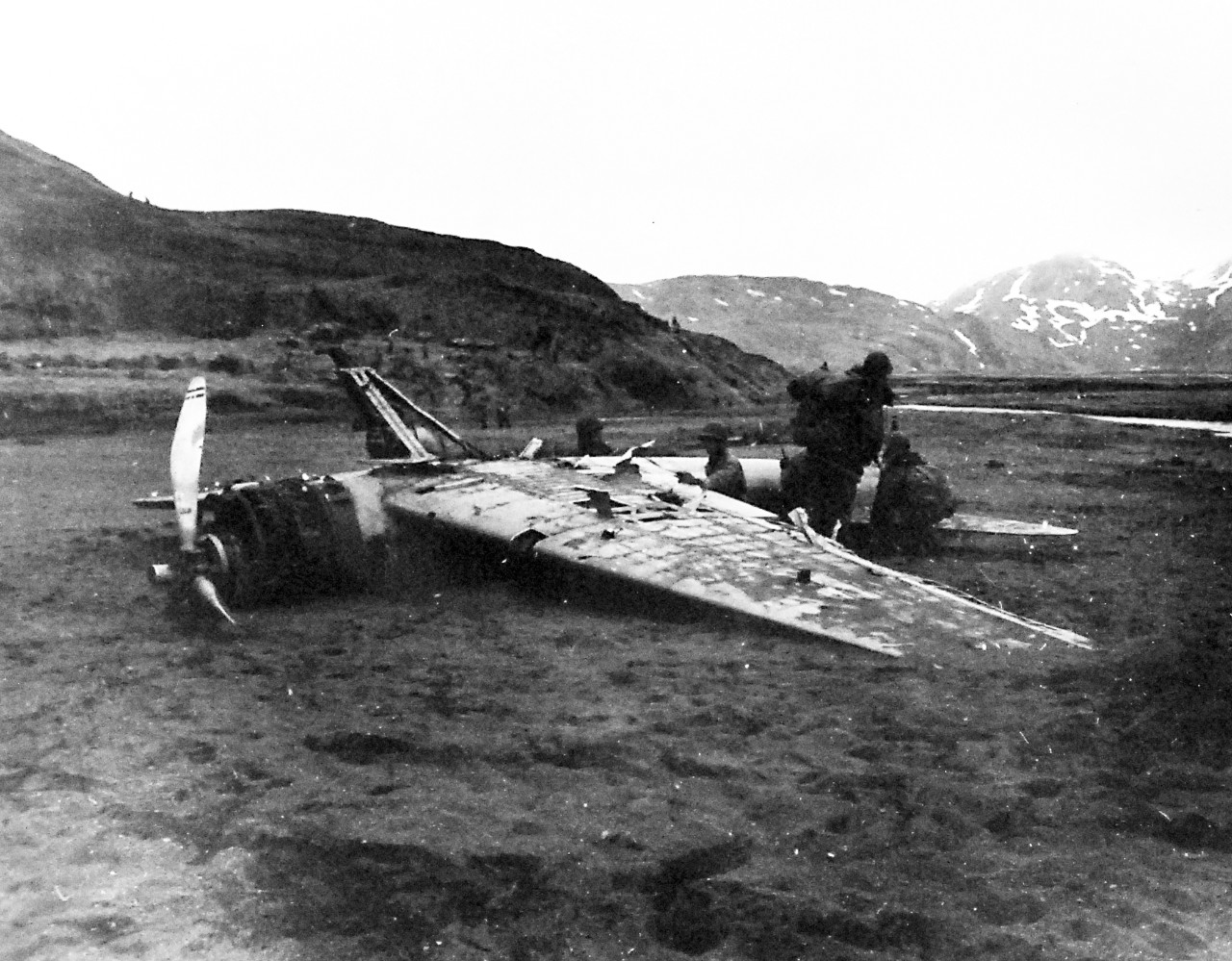 80-G-51010:    Aleutian Islands Campaign, June 1942 - August 1943.  Battle for Attu, May 1943.    U.S. Occupation of Attu, Aleutian Islands.  Japanese Zero, A6M-3N, plane damaged by American fire on Black Beach, Heltz Bay. May 17, 1943.     U.S. Navy Photograph, now in the collections of the National Archives.  (2016/05/10).