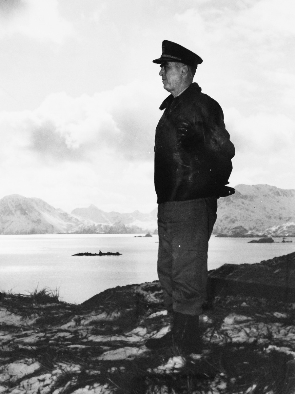 LC-Lot-803-20:  Aleutian Islands Campaign, June 1942 - August 1943.   Vice Admiral Thomas C. Kinkaid, USN, Commander, North Pacific Force, looks out over Kuluk Bay from the store of Adak Island in the Aleutians, where an American advance base is located.   Photograph released June 4, 1943.  Photographed through Mylar sleeve. Courtesy of the Library of Congress.    (2015/11/06).