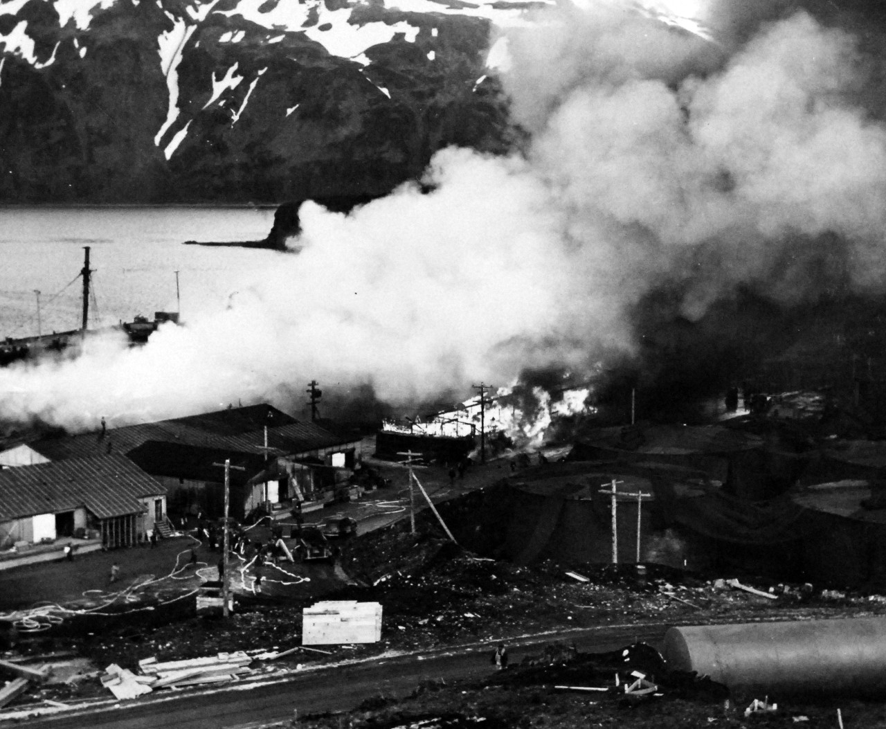 80-G-592:  Attack on Dutch Harbor,  Alaska,  June 1942.   SS Northwestern and Seims-Drake Warehouse burning after a bomb it, 4 June 1942.  Official U.S. Navy Photograph, now in the collections of the National Archives.    (2014/5/29).