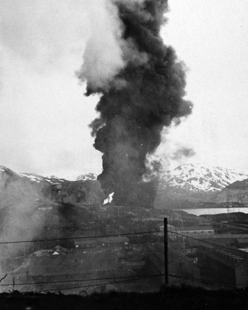 80-G-610:  Attack on Dutch Harbor,  Alaska,  June 1942.   Fire and smoke from Navy oil tanks burning after bombing, 4 June 1942.  Official U.S. Navy Photograph, now in the collections of the National Archives.    (2014/5/29).