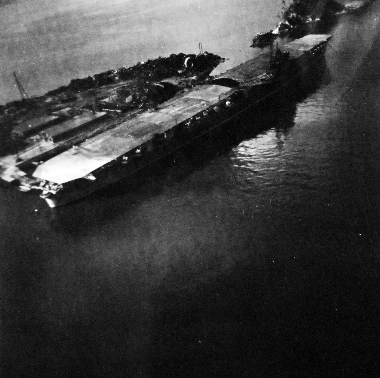 80-G-349907:   Damaged Japanese ships in Kure Harbor, Japan.  Shown is Japanese aircraft carrier Katsuragi.   Photographed by aircraft from USS St. George (AV 16), 14 October 1945.  (6/19/2014). 