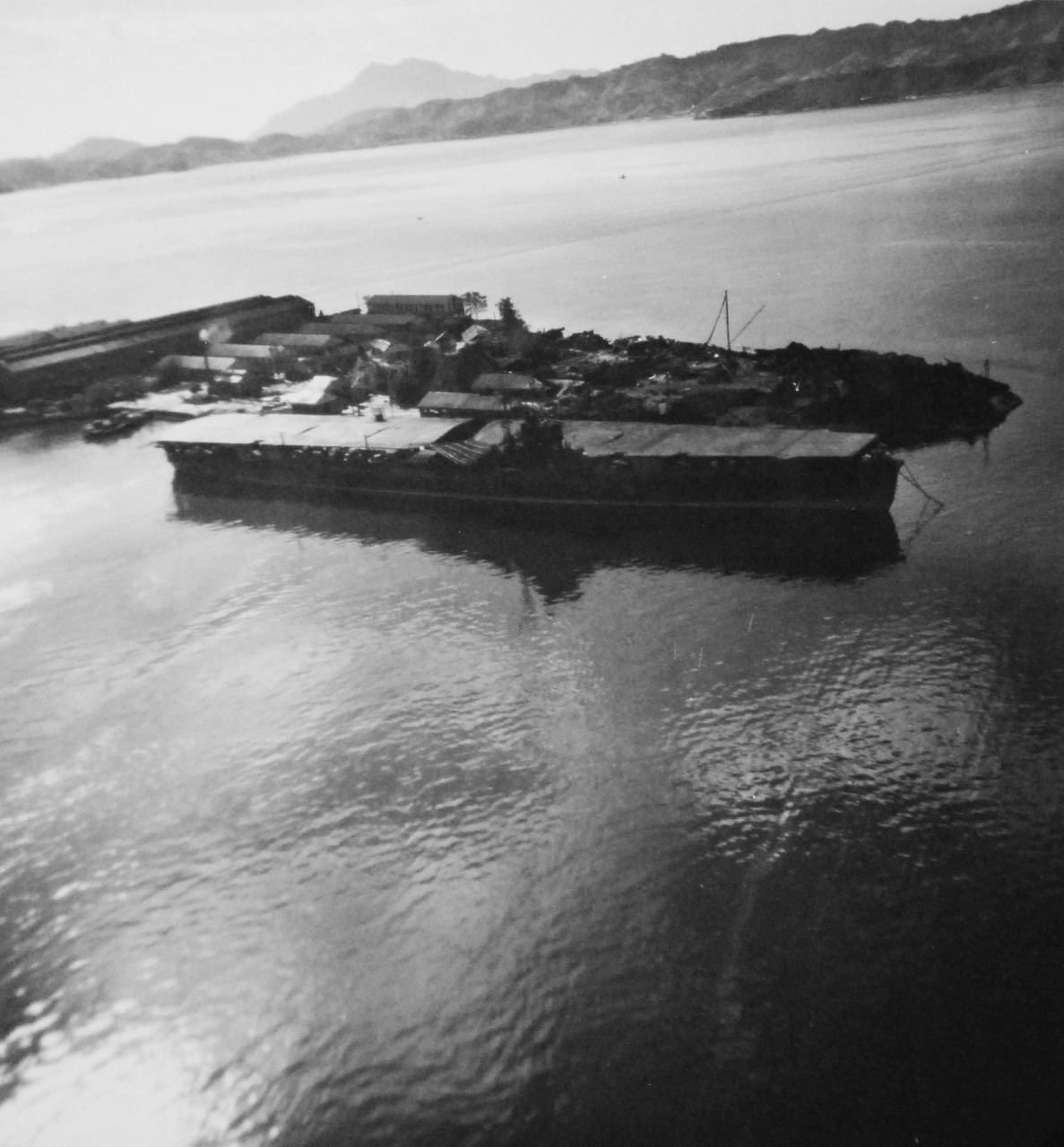 80-G-349908:   Damaged Japanese ships in Kure Harbor, Japan.  Shown is Japanese aircraft carrier Katsuragi.   Photographed by aircraft from USS St. George (AV 16), 14 October 1945.  (6/19/2014). 