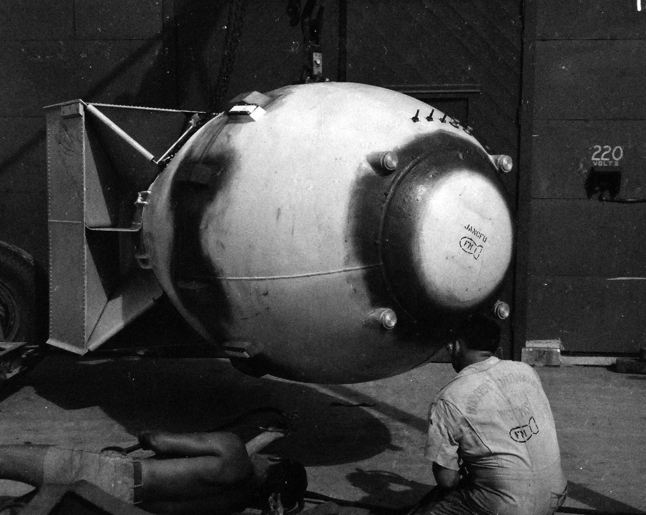 77-BT-186:   Tinian Island, August 1945.   Polar cap of atomic bomb, Fat Man, being sprayed with platic paint before assembly in building #2.   Official photograph of the Office of Chief of Engineers, now in the collection of the National Achives.   (2015/08/25). 