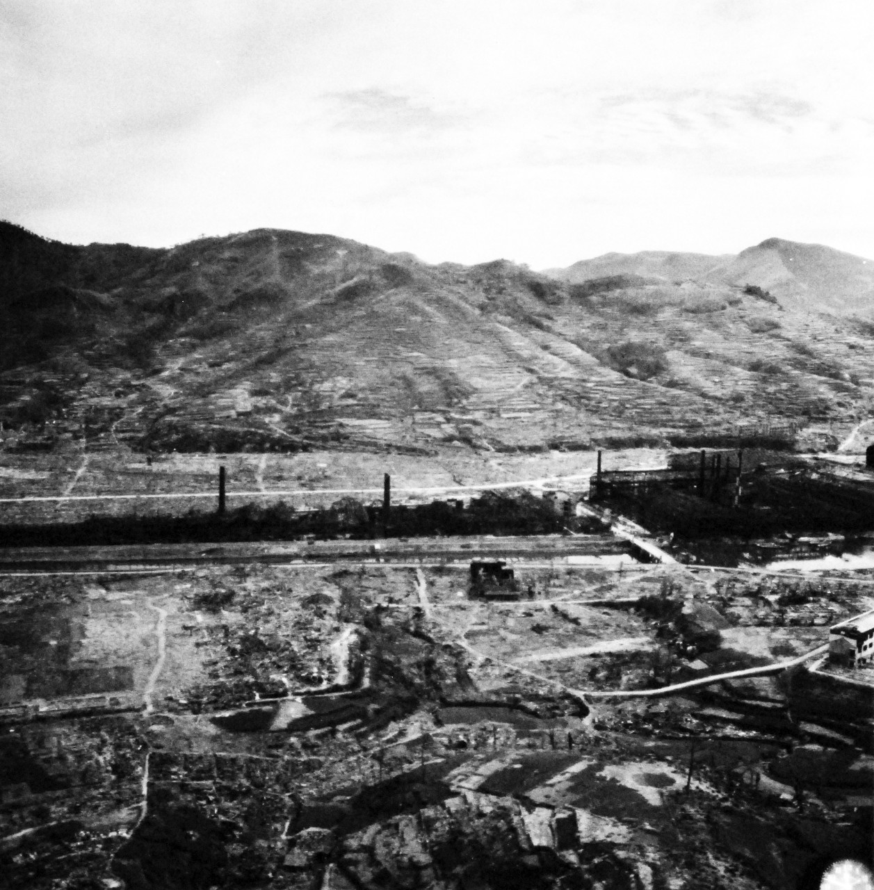 80-G-264898:   Nagasaki, Japan, 1945.  Aerial view of the bomb damage from August 9, 1945.  Altitude of 300’.  Photographed by USS Chenango (CVE-28) aircraft on October 15, 1945.  Official U.S. Navy photograph, now in the collections of the National Archives.   (2015/12/01).