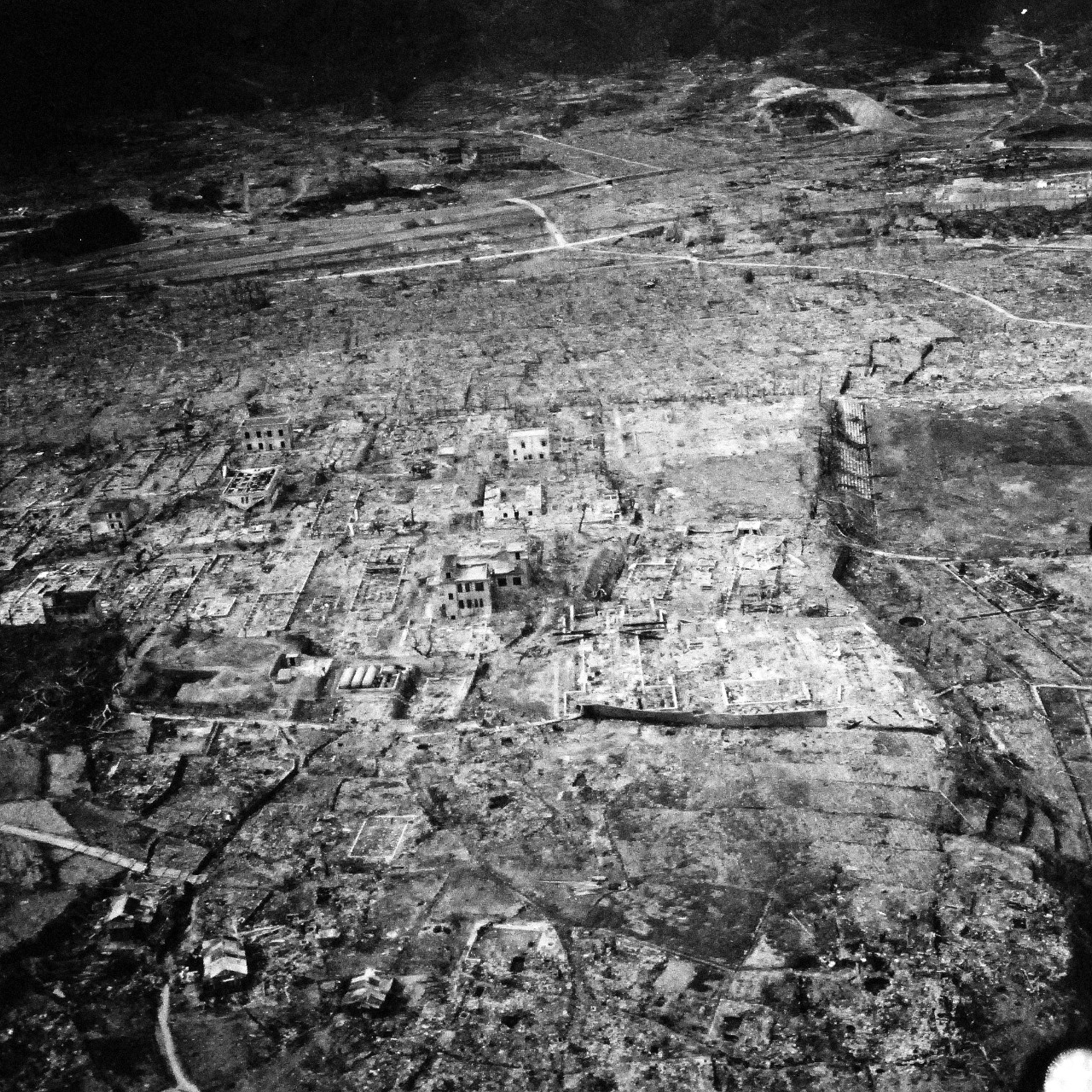 80-G-264905:   Nagasaki, Japan, 1945.   Aerial view of the bomb damage from August 9, 1945.  Altitude of 300’.  Photographed by USS Chenango (CVE-28) aircraft on October 15, 1945.  (2015/12/01).   Official U.S. Navy photograph, now in the collections of the National Archives.   (2015/12/01).