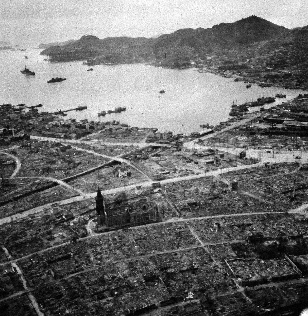 80-G-264906:   Nagasaki, Japan, 1945.   Aerial view of the bomb damage from August 9, 1945.  Altitude of 300’.  Photographed by USS Chenango (CVE-28) aircraft on October 15, 1945.  Official U.S. Navy photograph, now in the collections of the National Archives.   (2015/12/01).