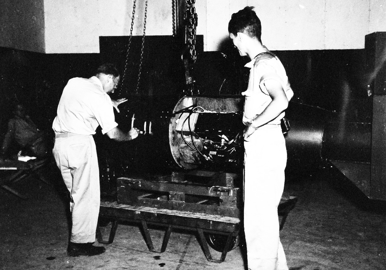77-BT-172:  Tinian Island, August 1945.   Commander A.F. Birch numbering atomic bomb, Little Boy, L-11, before loading on trailer in assembly building #1. Little Boy was dropped on Hiroshima, August 6, 1945.  Official photograph of the Office of Chief of Engineers, now in the collection of the National Achives.   (2015/08/25). 