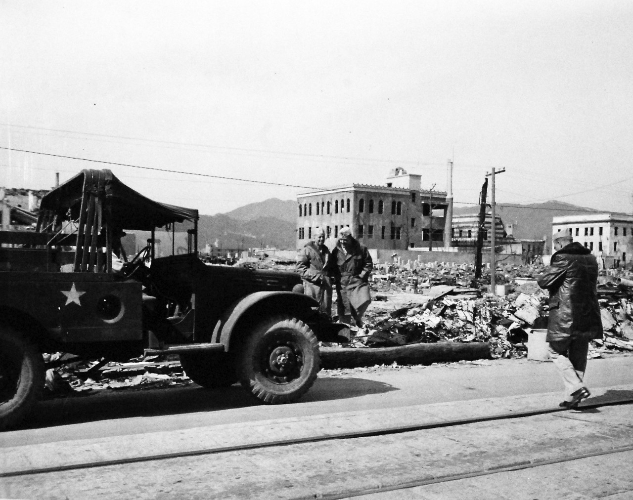 80-G-354615:  Hiroshima, Japan, 1945.   Atomic Bomb Damage to Hiroshima, as seen by USS Appalachian (AGC-1).   Captain J. B. Renn and Lieutenant Shelley of USS Appalachian (AGC-1) at Hiroshima. Photographed by PhoM3/C George Almarez.  Photographed received October 26, 1945.    U.S. Navy photograph, now in the collections of the National Archives.  (2016/06/21).
