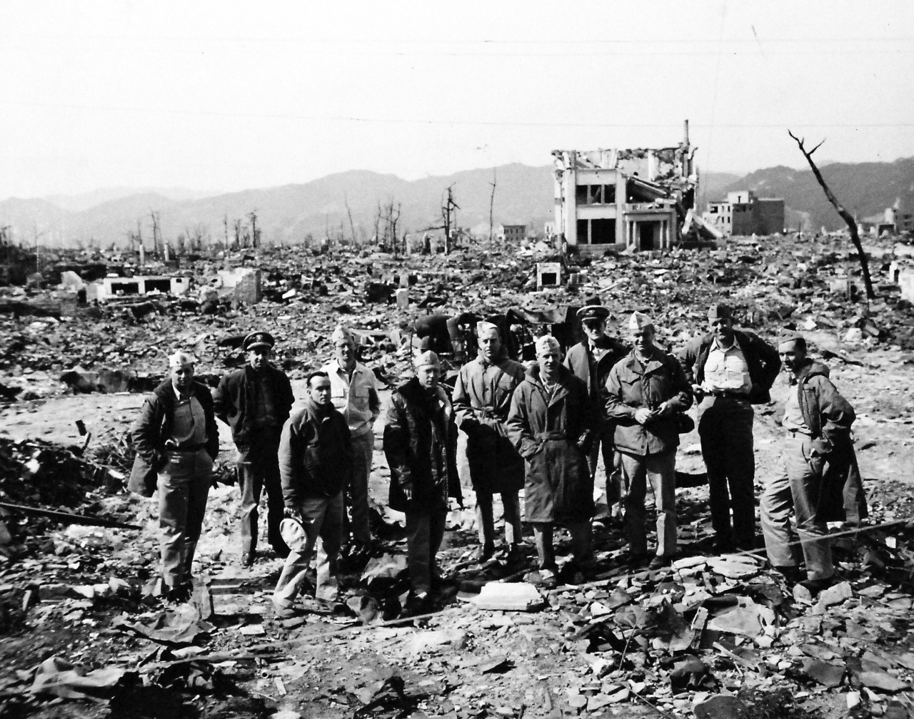 80-G-354619:  Hiroshima, Japan, 1945.   Atomic Bomb Damage to Hiroshima, as seen by USS Appalachian (AGC-1).   Officers of USS Appalachian (AGC-1) at bomb damaged Hiroshima. Photographed by PhoM3/C George Almarez.  Photographed received October 26, 1945.  U.S. Navy photograph, now in the collections of the National Archives.  (2016/06/21).