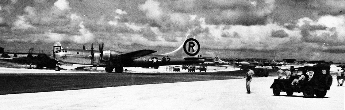 Image:   77-BT-91:  Tinian Island, August 1945.   Boeing B-29 Superfortress, “Enola Gay” returns home after the strike at Hiroshima, August 6, 1945.  Note, the aircraft entering hard sand.   Official Photograph of the Office of the Chief of Engineers, now in the collections of the National Archives.  
