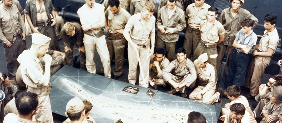 Image:  USMC 67706:   Tarawa Operation, November 1943.  U.S. Marines and Sailors study a relief model of Betio Island while en-route to the invasion, mid-November 1943.   Official U.S. Navy Photograph, now in the collections of the National Archives.   