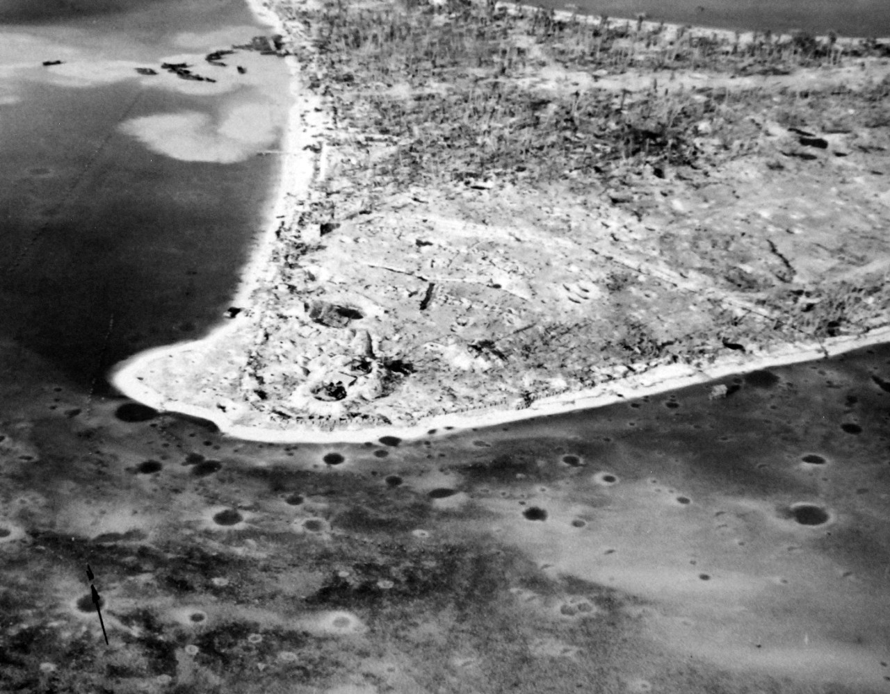 80-G-202847:  Battle of Tarawa, November 1943.   Oblique of Betio Island, Tarawa, during the invasion of U.S. Marines.  Shown:  South west tip of island showing gun emplacements and trenches.  Photographed with K-20 camera by planes from USS Chenango (CVE 28), November 22, 1943.     U.S. Navy photograph, now in the collections of the National Archives.  (2017/04/04).