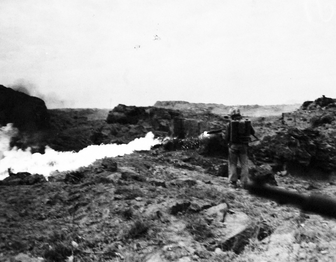 127-GW-320-114786:  Iwo Jima Operations, Feb-March 1945.   Sergeant Leonard J. Shoemaker, Newberry, Michigan, uses his flame thrower on Japanese caves in mopping up operation on Iwo Jima. Photographed by Simpson, February 27, 1945.   Official U.S. Marine Corps Photograph, now in the collections of the National Archives.  (2016/09/06).