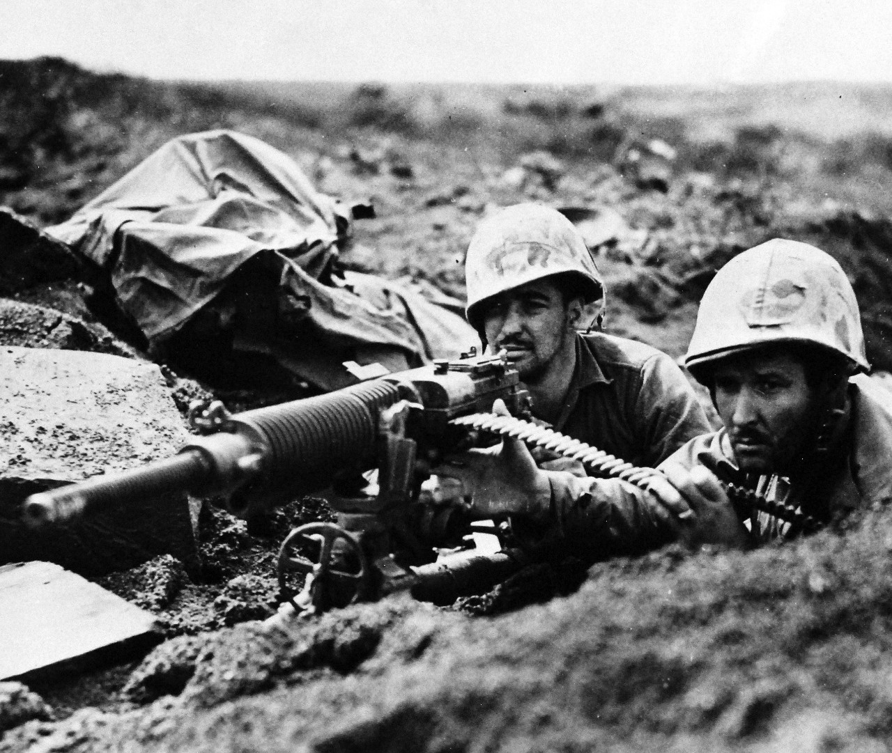 80-G-304847:  Battle for Iwo Jima, February-March 1945.  After their own gun was knocked out on Iwo Jima, Marines of the Fifth Division took over this captured Hotchkiss machine gun and gave the enemy back some of its down lead.  Shown, (left to right):  Corporal A.R. Cassavant and Corporal Thomas McLennon.   Photograph released February 25, 1945.  Official U.S. Navy Photograph now in the collections of the National Archives.  (2016/01/19).