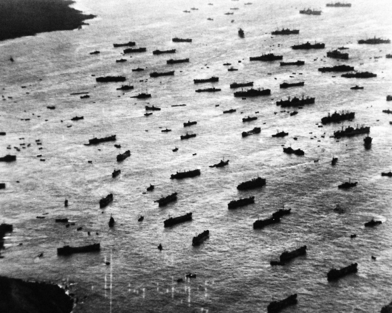 80-G-307206: Battle for Iwo Jima, February 1945.  U.S. Ships and landing craft anchored off East beach on Iwo Jima during landing operations.    Photographed by plane from USS Saginaw Bay (CVE-82), February 27, 1945.    U.S. Navy photograph, now in the collections of the National Archives.  (2016/09/06).