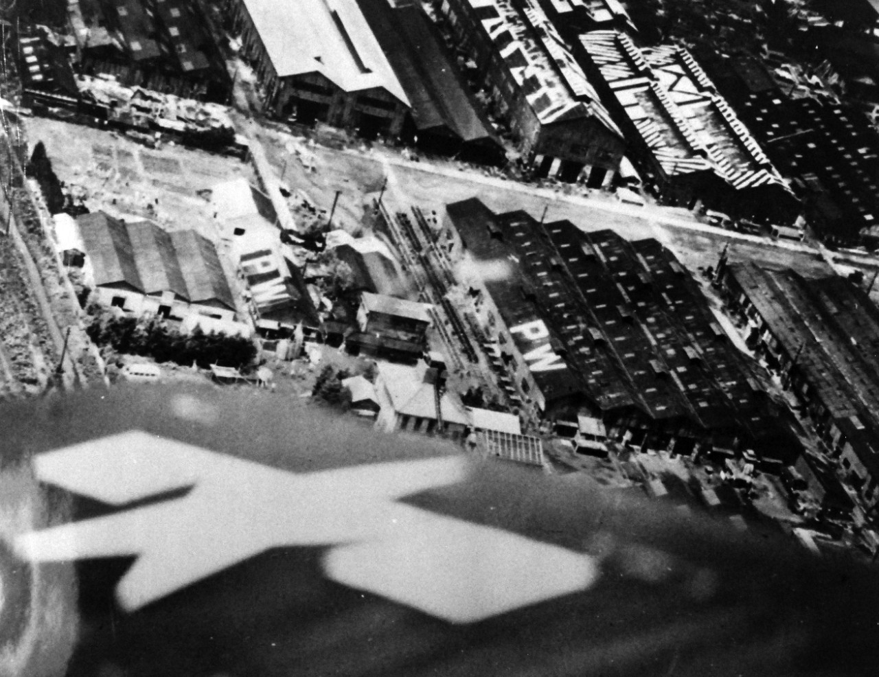 80-G-490390:  Allied Prisoner of War Camp, Tokyo, 1945.  Low aerial of Allied prisoners of war in Tokyo, Japan, area.  Photographed after food was dropped from planes. Note the PW on the rooftops. Released August 29, 1945.  .  Official U.S. Navy Photograph, now in the collections of the National Archives.   (2015/11/10).