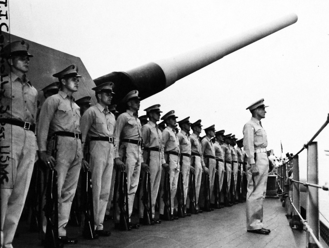 127-GW-1549-134503:  Formal Japanese Surrender, September 2, 1945.    Marine Honor Guard at the formal surrender to Allied powers onboard USS Missouri (BB 63) in Tokyo Harbor, Japan.  The Leathernecks are shown here standing at stiff attention on the quarterdeck beneath the long barrels of the 16” guns as representatives of the various governments come onboard for the ceremonies.   Photographed by Connolly.  Official U.S. Marine Corps Photograph, now in the collections of the National Archives.  (2016/05/03).  