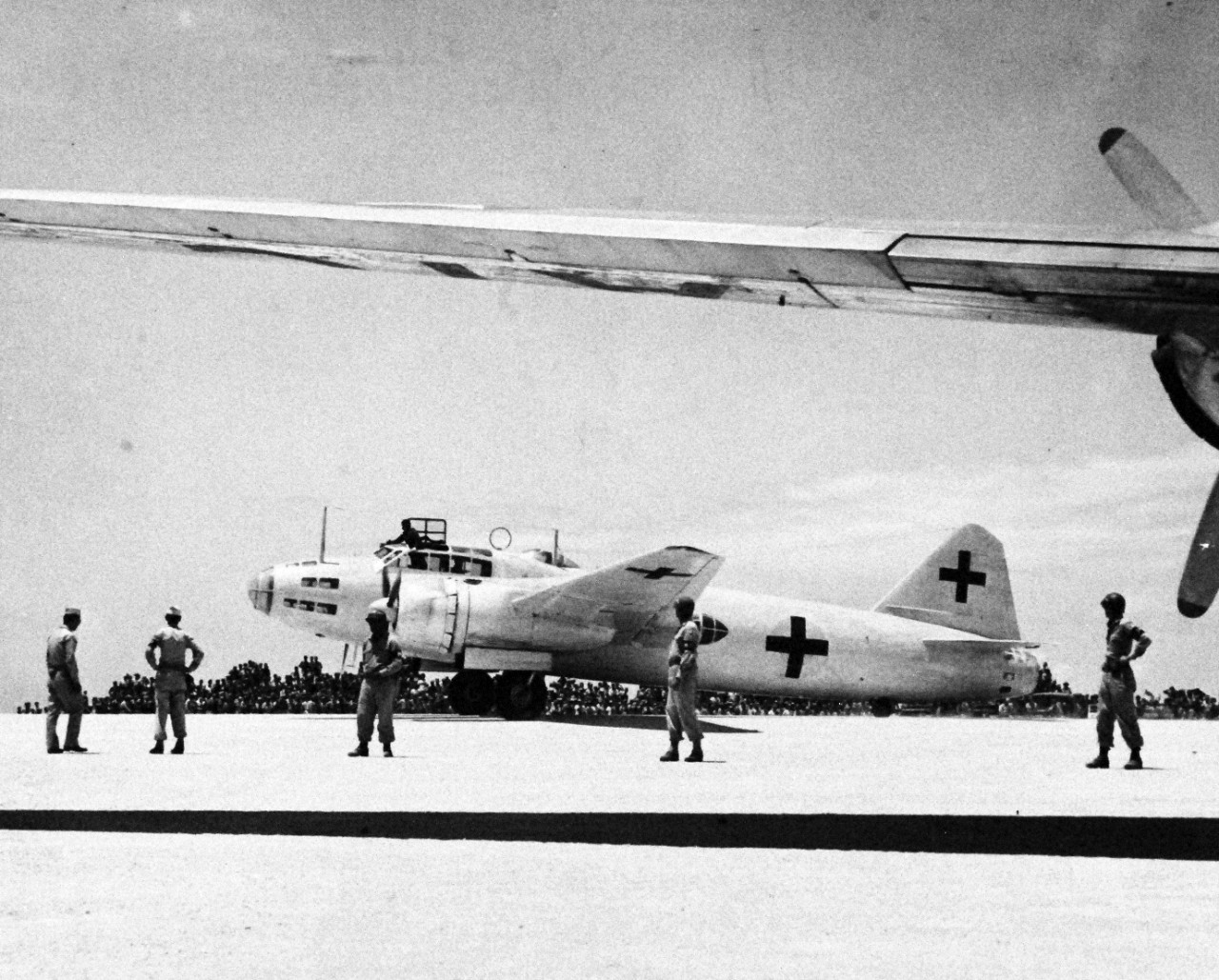 80-G-490351:  Surrender of Japan, August-September 1945.  A Japanese Mitsubishi G4M “Betty” which carried the envoys from Japan to General Douglas MacArthur in Manila, stops at Ie Shima airfield before proceeding to the Philippines, which will lead to the formal Japanese Surrender on September 2, 1945.  Note the Red Crosses on the plane. Photograph released August 19, 1945.  Official U.S. Navy Photograph, now in the collections of the National Archives.  (2015/11/10).