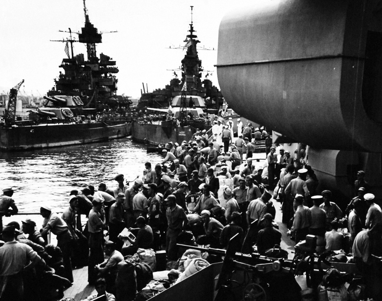80-G-495679:  Operation Magic Carpet, 1945.   Crowded with men bound for home are (left to right, USS Colorado (BB-45), USS West Virginia (BB-48) and USS Iowa (BB-61) at Pearl Harbor.  The picture was taken from one of the decks of Iowa.   Photograph released 8 October 1945.  Official U.S. Navy photograph, now in the collections of the National Archives.   (2014/5/29). 