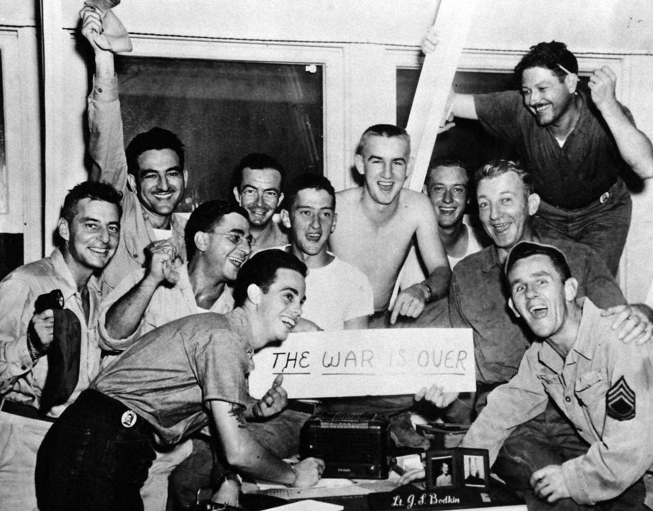 80-G-490285:  V-J Day, August 15, 1945.      Victory Celebrations (VJ Day) at CINCPAC HQ, Guam, August 15, 1945.  Shown:  T/5 Carl Gurtcheff, AUS; CPL. Vic Colucci; PHOM2/C Arthur Ryding, USN; PHOM2 Clifford Martin; PHOM2 William Reigger; PHOM2/C James Badgett; PHOM2/C J.F. Whitely; SP(P)2/C Dan Brown; PHOM1/C Clayton Aylor; and TSGT Denny O’Neill.   Official U.S. Navy photograph, now in the collections of the National Archives.   (2015/11/10).