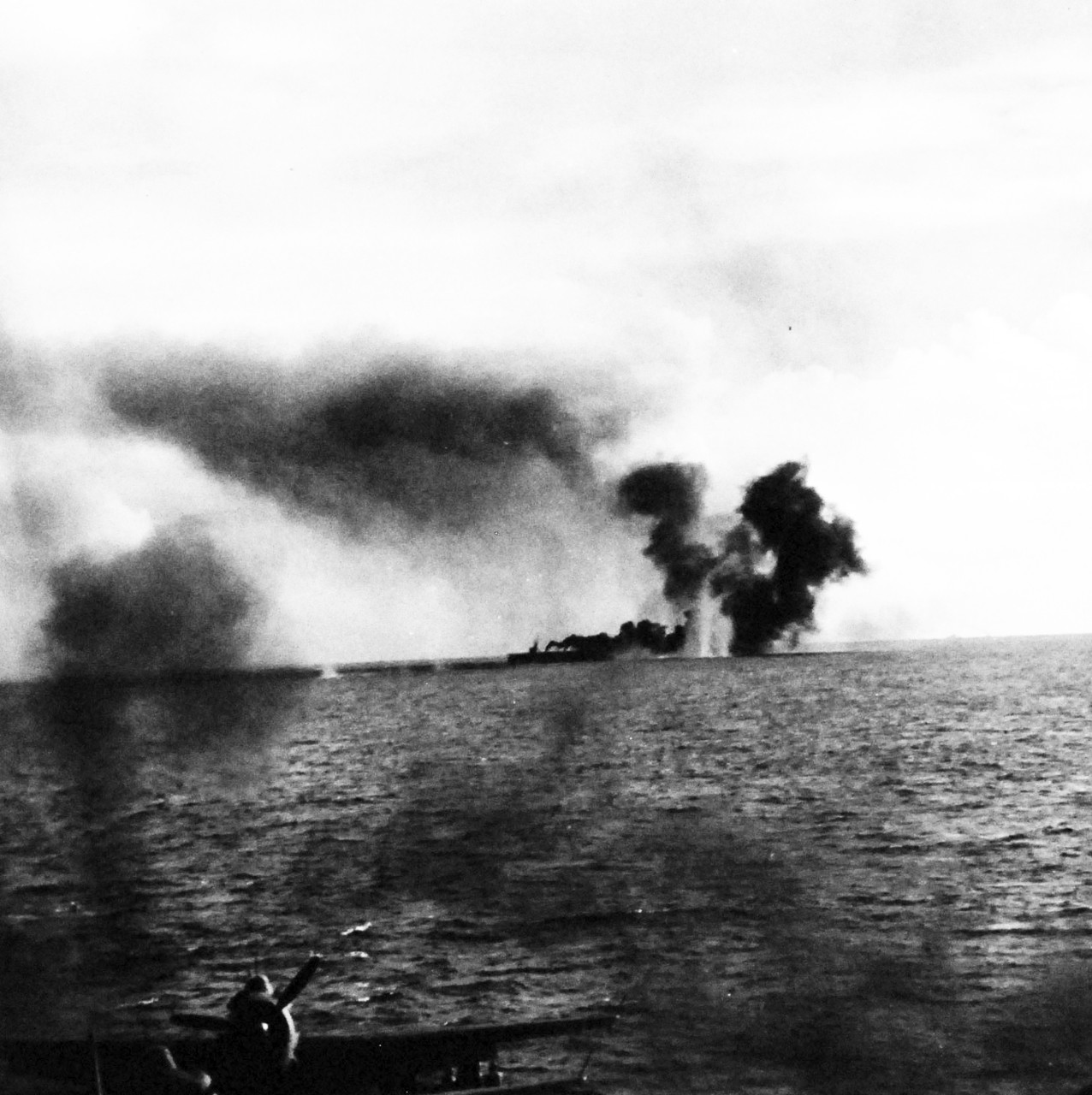 80-G-287503:   Battle off Samar, October 25, 1944.     A Japanese cruiser (on horizon) a unit of fleet moving on Philippines shells a carrier-escort during the Battle of Leyte Gulf.  As seen from USS Kitkun Bay (CVE-71).   Shown as the salvo is put astern.   Official U.S. Navy Photograph, now in the collections of the National Archives.  (2014/5/15).  