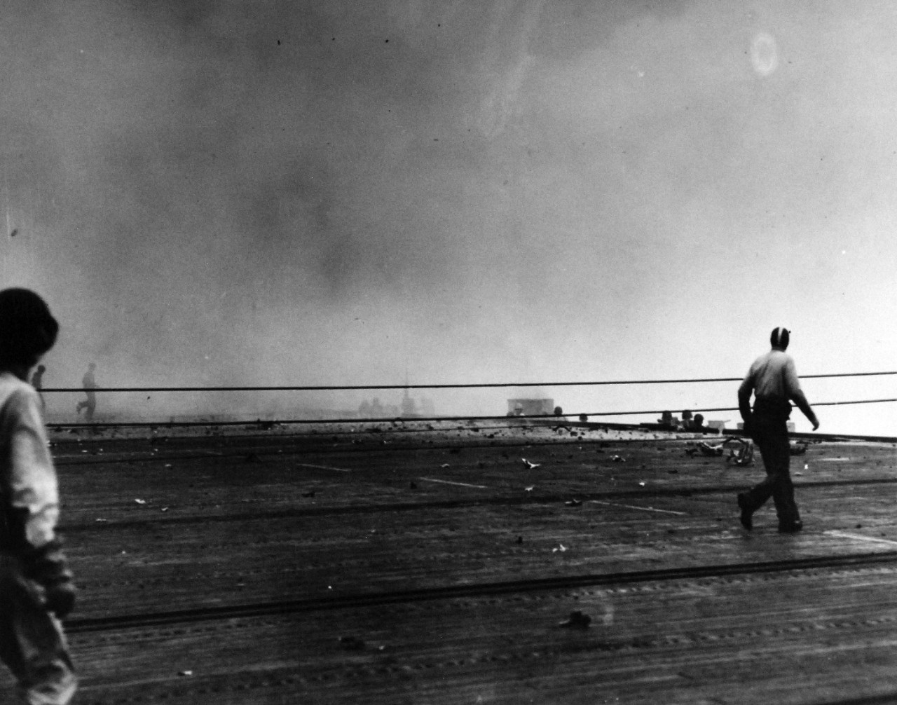 80-G-384159:  Battle of Leyte Gulf, 24-26 October 1944.   USS White Plains (CVE-66) after suicide dive by Japanese “Zeke.”  Smoke from explosion still present.     White Plains served with Task Group 77.4 during the battle and was assigned to Taffy 3, led by Rear Admiral C.A.F. Sprague.    Official U.S. Navy Photograph, now in the collections of the National Archives.     (2015/3/4/2015). 