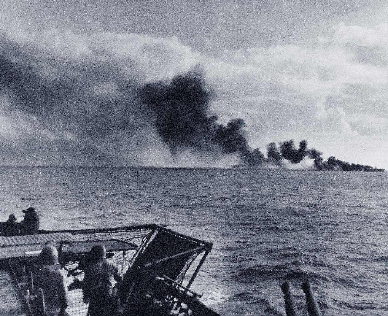 80-G-384160:  Battle of Leyte Gulf, Battle off Samar, October 25, 1944. CVE, possibly USS Gambier Bay (CVE-73) receives attack by Japanese surface units, as seen from USS White Plains (CVE-66). Official U.S. Navy Photograph, now in the collections of the National Archives.    (2015/3/4).