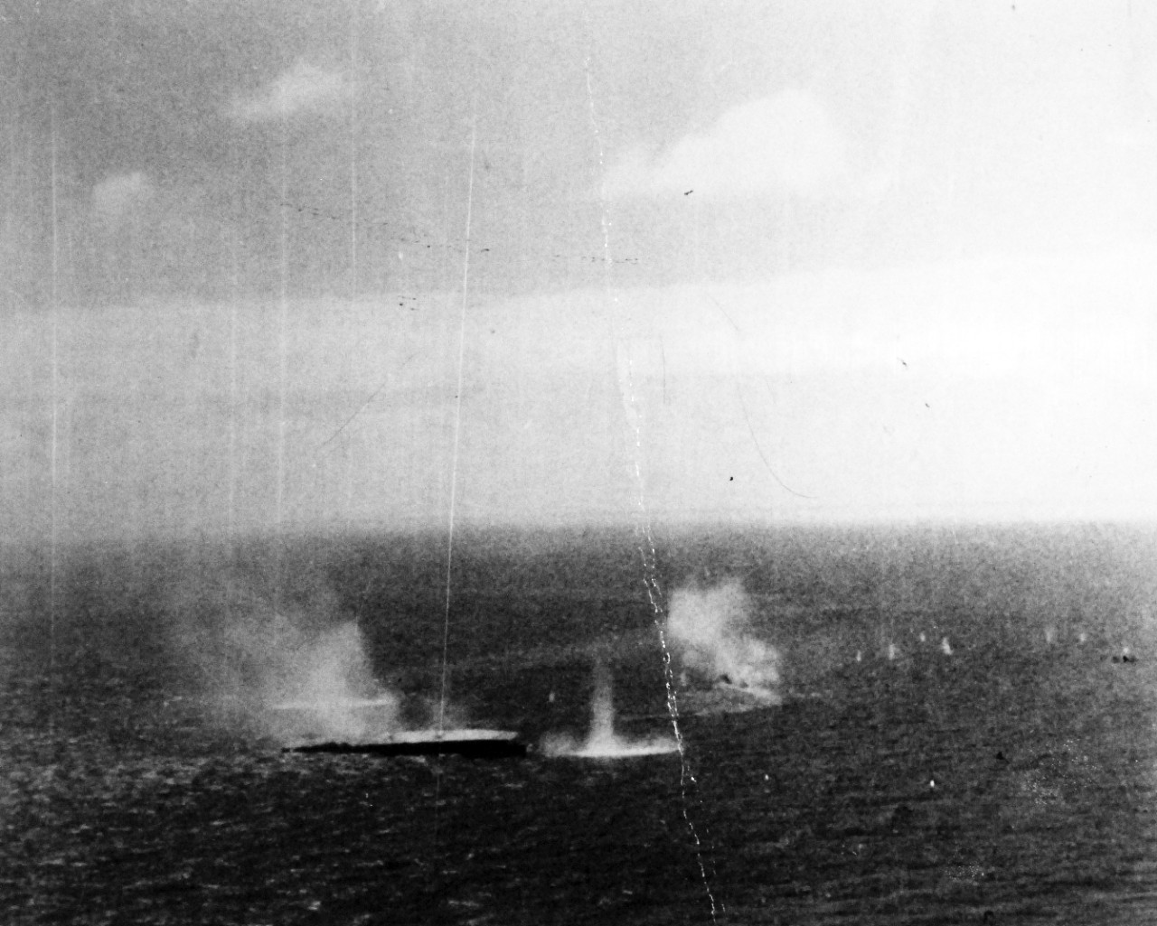 80-G-272553:   Battle of the Sibuyan Sea, October 24, 1944.  Japanese warships under attack by carrier-based planes.  Note the light aircraft carrier, Zuiho, listing in the water.   Taken from by a plane from USS Franklin (CV-13).   Official U.S. Navy Photograph, now in the collections of the National Archives.   (2014/5/15).