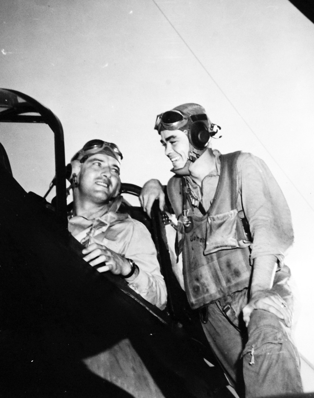 80-G-285082:  Battle of the Sibuyan Sea, October 24, 1944.   Lieutenant Commander Arthur L. Downing and ARM2 John L. Carver following their return to carrier after successful bombing of Japanese battleship Yamato during the Battle of Leyte Gulf. In an SB2C, they dropped two bombs just forward of No.1 gun turret, going in through intense anti-aircraft fire at low altitude.  Left to right:  ARM2C Carver and Lieutenant Commander Downing.  This bombing was probably from aircraft based onboard USS Essex (CV-9).   Yamato was later sunk by U.S. Navy aircraft on April 7, 1945.   Photograph released October 25, 1944.  U.S. Navy photograph, now in the collections of the National Archives.  (2016/03/15). 