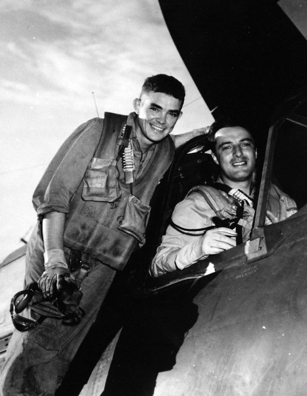 80-G-285084: Battle of the Sibuyan Sea, October 24, 1944.   Lieutenant Commander Arthur L. Downing and ARM2 John L. Carver following their return to carrier after successful bombing of Japanese battleship Yamato during the Battle of Leyte Gulf. In an SB2C, they dropped two bombs just forward of No.1 gun turret, going in through intense anti-aircraft fire at low altitude.  Left to right:  ARM2C Carver and Lieutenant Commander Downing.  This bombing was probably from aircraft based onboard USS Essex (CV-9).   Yamato was later sunk by U.S. Navy aircraft on April 7, 1945.   Photograph released October 25, 1944.  U.S. Navy photograph, now in the collections of the National Archives.  (2016/03/15). 