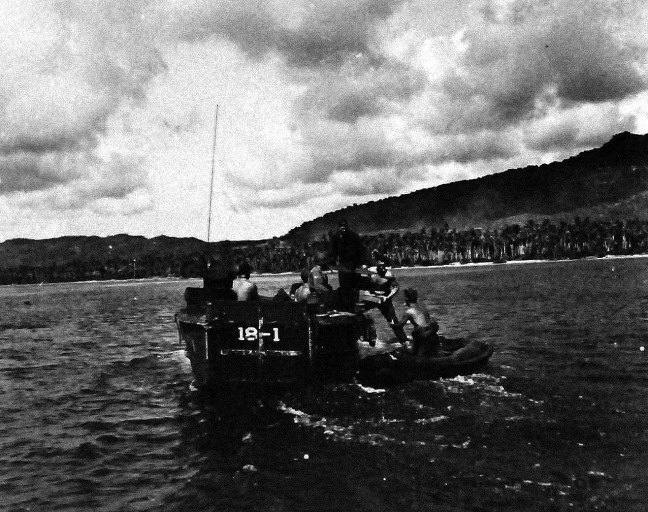 80-G-270819:  Invasion of Guam, July-August 1944.   Underwater Demolition Team on Guam, W-2 Day.   Taken by USS Honolulu (CL 48), received on 3 October 1945.   Image shows the team taking explosive from Higgins boat to rubber boat to be planted in the coral heads and cribs along the beach.  Official U.S. Navy Photograph, now in the collections of the National Archives.   (2013/9/13).
