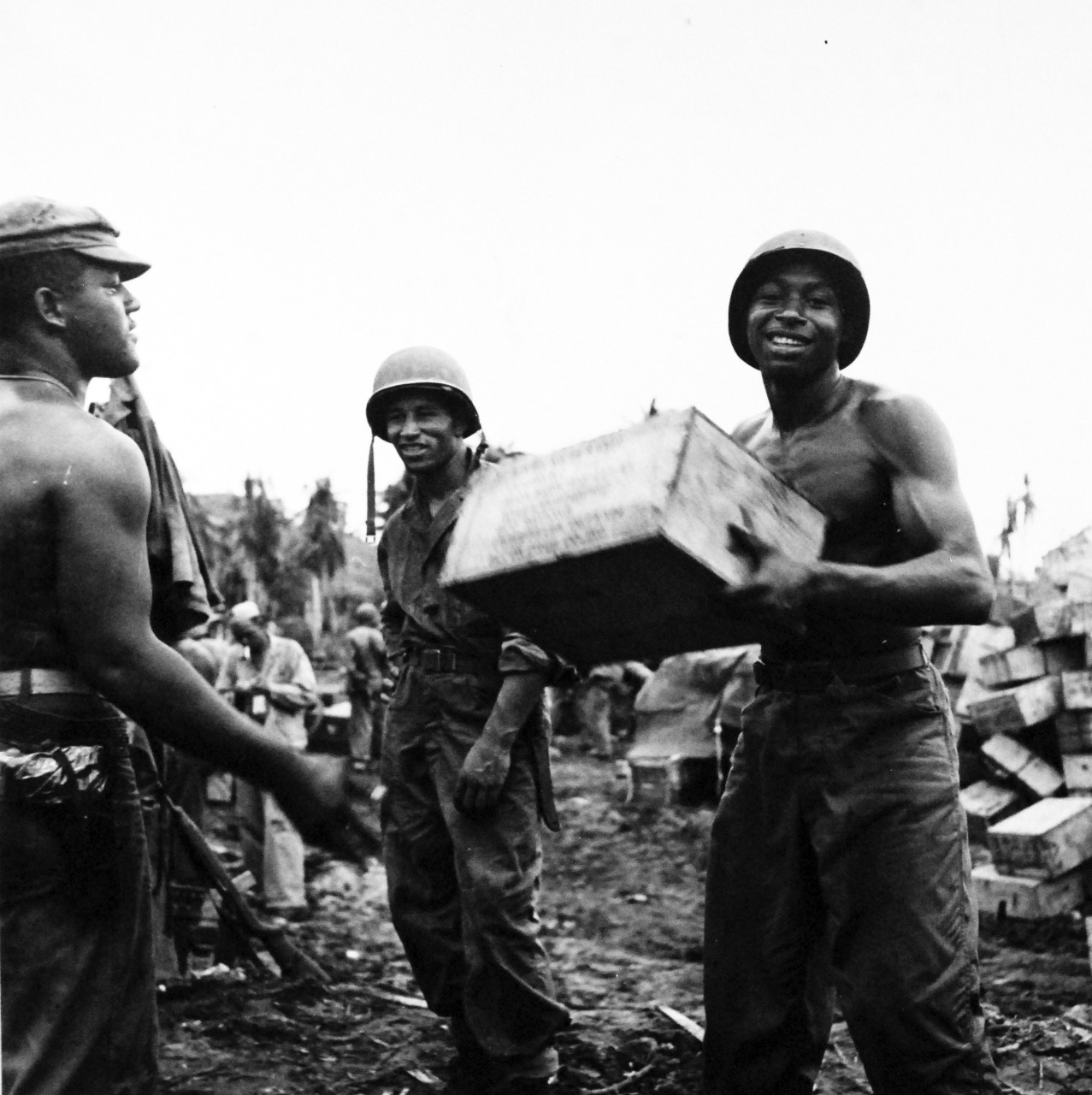 80-G-475161:  Invasion of Guam, July 21-August 10, 1944.  African-American ammunition handlers unload boxes for use in the battle.  Photographed by Lieutenant Paul Dorsey, July 1944, TR-10777.      Official U.S. Navy photograph, now in the collections of the National Archives.   (2017/03/15).