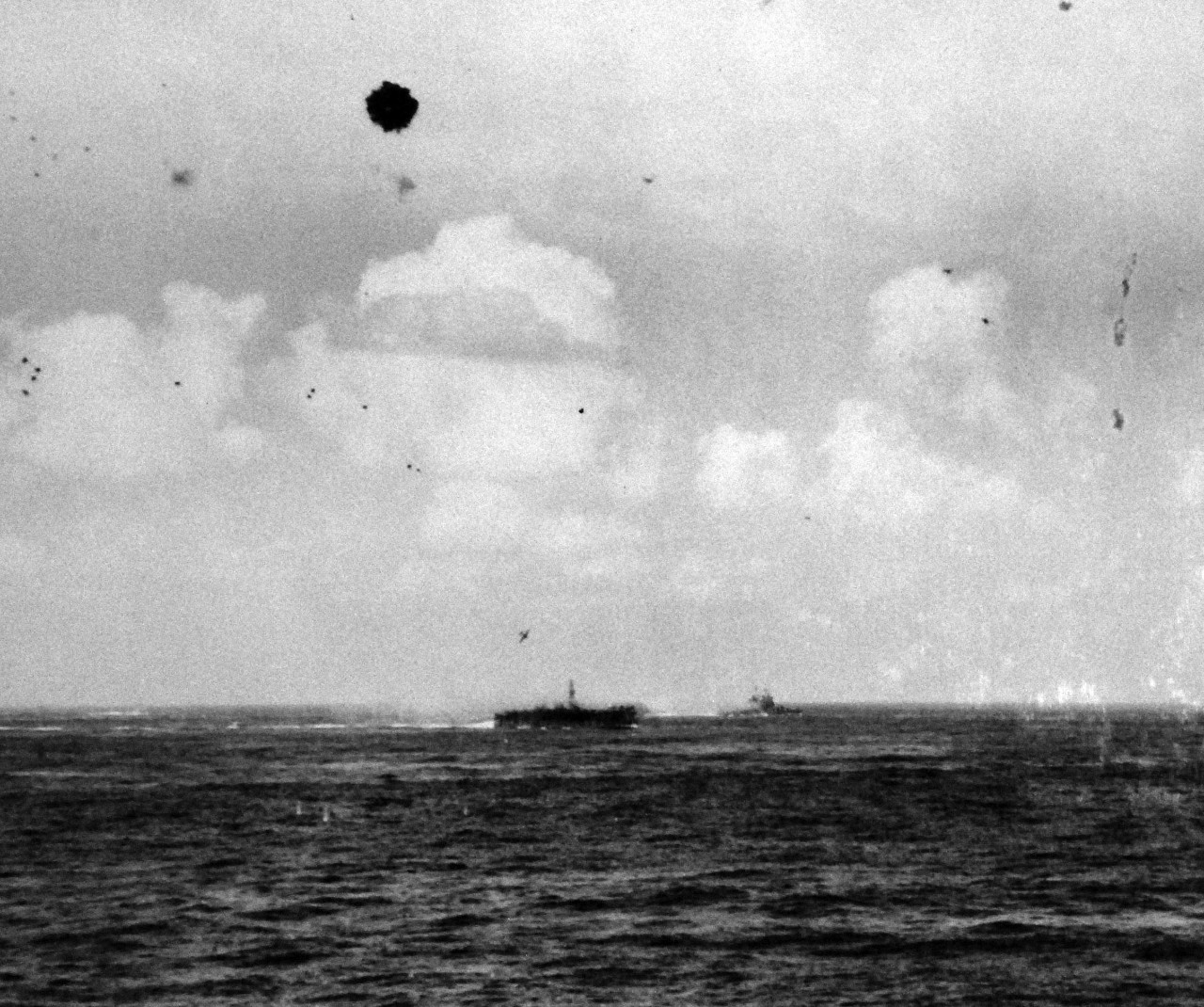 80-G-373773:    Okinawa Campaign, Pre-Landing Bombardment, Japanese Kamikaze, March 1945.    Near miss by Japanese plane on USS Bataan (CVL-29), unit of Task Force off Okinawa in the Ryukyu Islands.   As seen from USS Essex (CV-9),  Marh 17, 1945.  Official U.S. Navy Photograph, now in the collection of the National Archives.   (2014/5/8).   