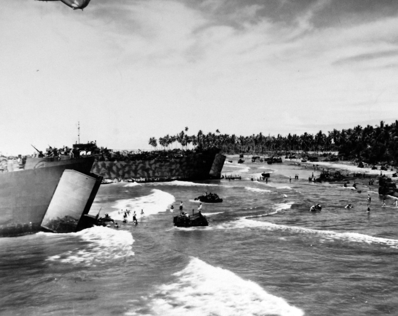 80-G-202489:  Bougainville Campaign, November 1943-August 1945.     Putting men and supplies ashore at Empress Augusta Bay, Bougainville Island.  Shown:  Unloading heavy equipment on shallow beach.   Photographed November 6, 1943.  Official U.S. Navy Photograph, now in the collections of the National Archives.  (2018/02/21).  