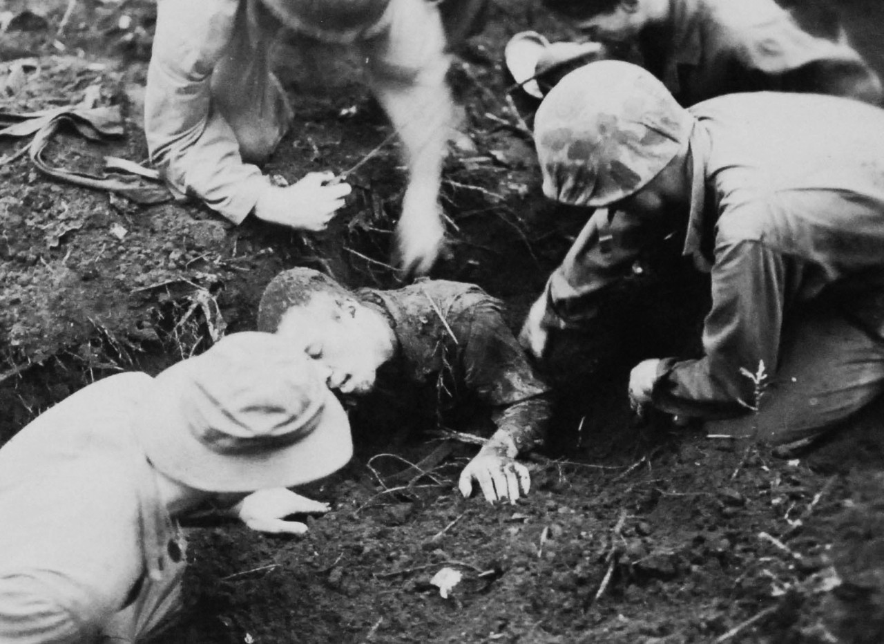 127-GW-971-71558:  Battle of Cape Gloucester, New Britain, December 1943-January 1944.   Japanese prisoner.  Marines dig out alive Japanese, only survivor when his pillbox was blasted during the Cape Gloucester Campaign.   Photographed by Sylvester, 27 December 1943.  Official U.S. Marine Corps Photograph, now in the collections of the National Archives.   (2014/7/9).