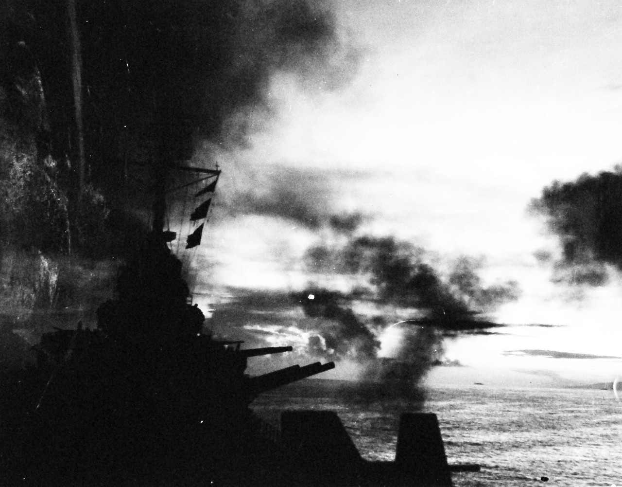80-G-57444:  Battle of Cape Gloucester, New Britain, December 1943-January 1944.   Bombardment of Cape Gloucester, New Britain, by USS Phoenix (CL-46) and other ships of the Task Force.  Taken by USS Nashville (CL-43), December 24-26 1943. Official U.S. Navy Photograph, now in the collection of National Archives.   (2015/6/2). 