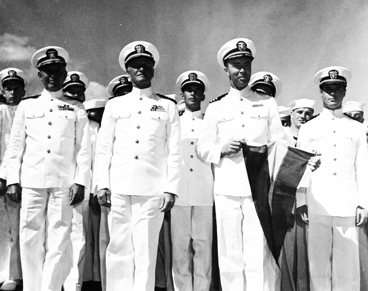 80-G-212209:  USS Nicholas (DD-449), 1944.   Admiral Chester W. Nimitz, USN, CincPac and Pacific Ocean Areas, (center) presented the Presidential Unit Citation to USS Nicholas (DD-449) for outstanding performance in action against enemy Japanese forces off Kolombangara Island, New Georgia group on July 5-6, 1943.  Commander R.T.S. Keith, USN, (right), Co of Nicholas holds the banner.  Rear Admiral J.L. Kauffman, USN, Commander Destroyers, Pacific Fleet, stands at the left.  Ceremony took place at Pearl Harbor, January 29, 1944.    U.S. Navy Photograph, now in the collections of the National Archives.  (2017/05/02).  