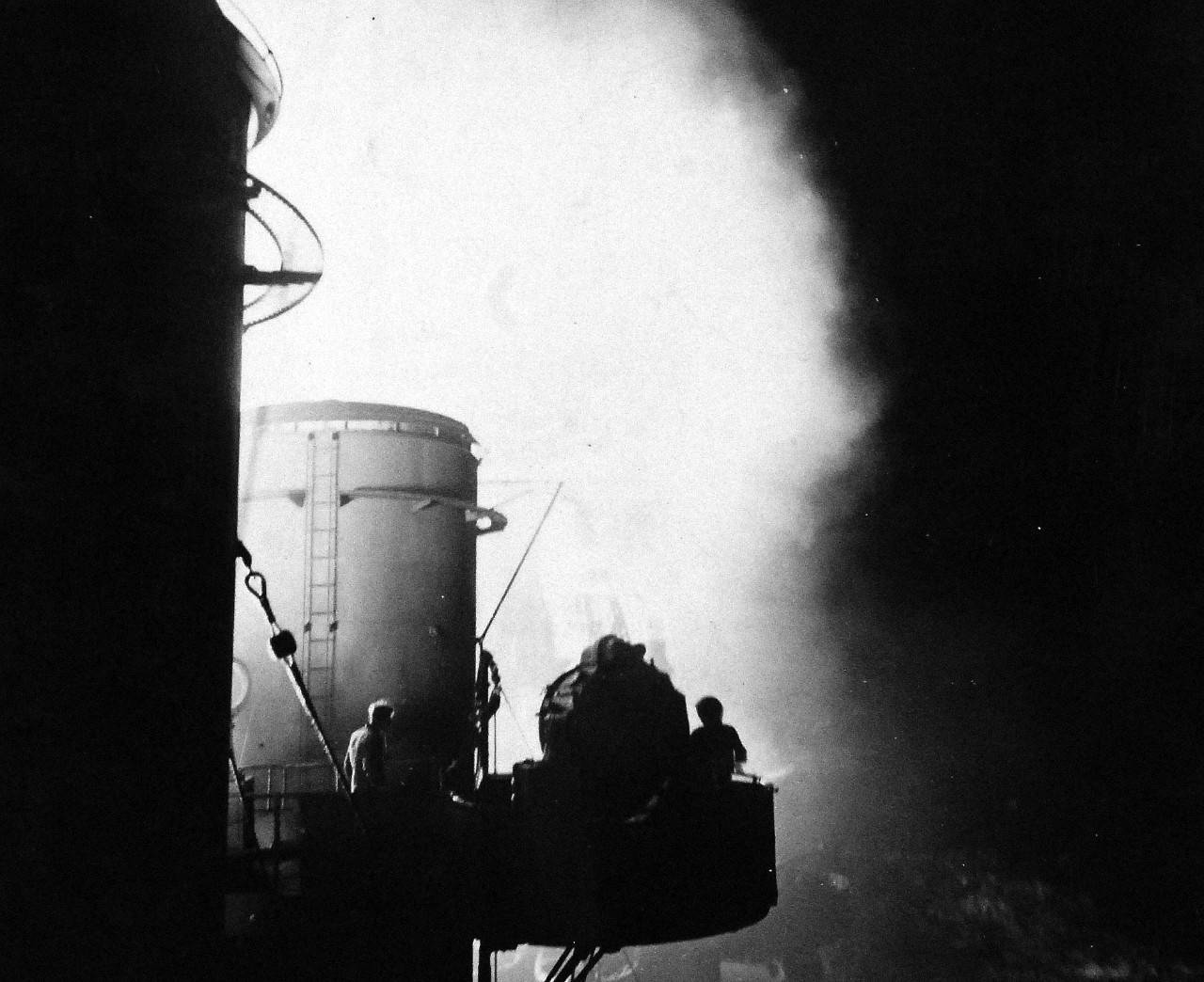 80-G-54562:  Battle of Kula Gulf, July 5-6, 1943.   Aboard USS Honolulu (CL-48).  Searchlight platform silhouetted against the glare from the firing guns.  Photograph, July 1943.   Official U.S. Navy photograph, now in the collections of the National Archives.   (2016/07/19).