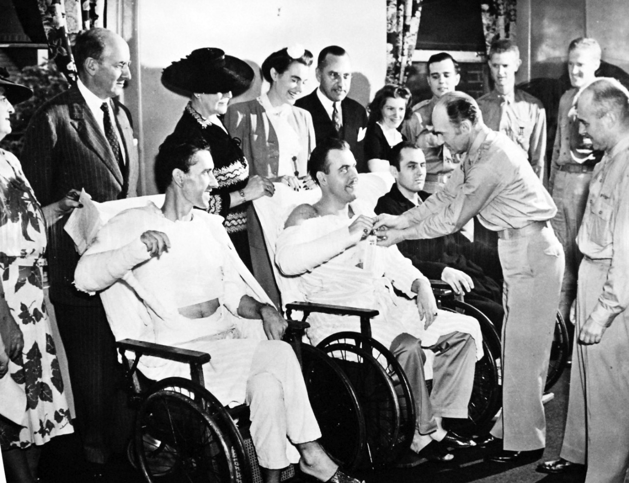 111-SC-21321AC:   Doolittle Raid on Japan, April 18, 1942.   Courage and wounds are honored at Walter Reed Hospital, Washington, D.C., in the first such ceremony conducted at the Army Medical Center during the war.  Shown:  Major General Millard F. Harmon, Chief of Air Staff of the AAF pinning the Distinguished Flying Cross on one of the members of the group which flew with Major General Doolittle in the raid over Japan.  Former Secretary of the Treasury, Henry Morgenthau, second from left, back row.  Major General Doolittle at right of front row.  U.S. Army Photograph, now in the collections of the National Archives.  (2017/05/02).