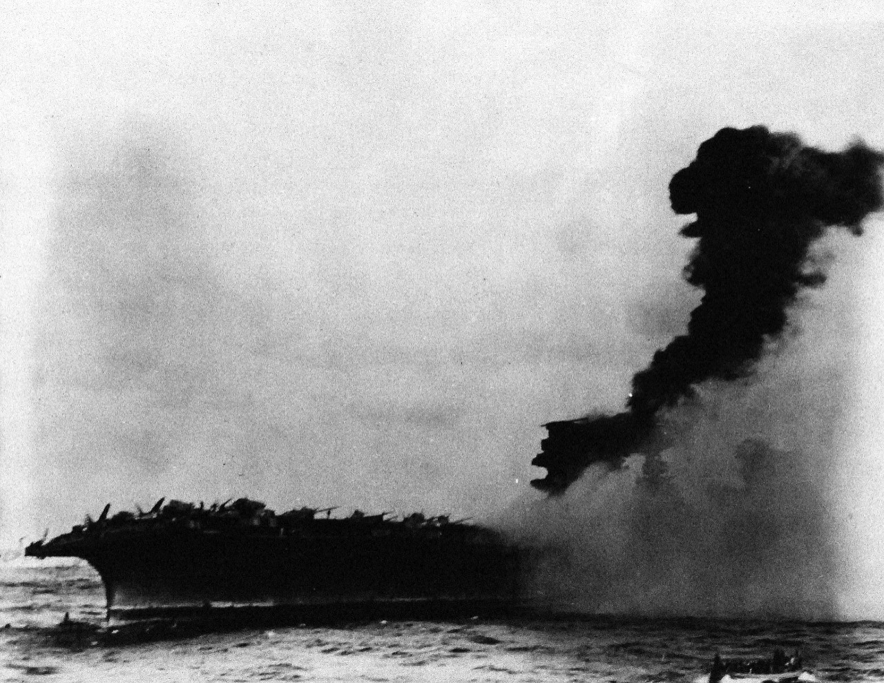 80-G-16637:  Battle of the Coral Sea, May 1942.  Abandoning of USS Lexington (CV 2) following the Battle of the Coral Sea, 8 May 1942.   Small explosions amid-ship is visible.    Official U.S. Navy Photograph, now in the collections of the National Archives.    (4/10/2014). 