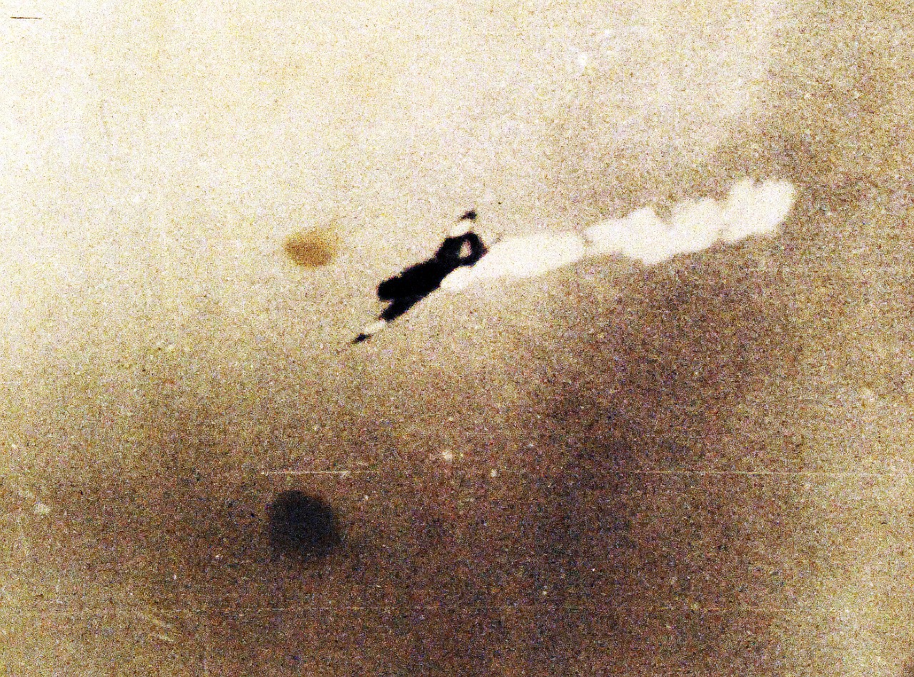 80-G-16638:   Battle of the Coral Sea, May 1942.  Japanese Type 97 Shipboard Attack Plane ("Kate" torpedo bomber) is hit by anti-aircraft fire during attacks on the U.S. aircraft carriers, late in the morning of 8 May 1942.  (4/10/2014).