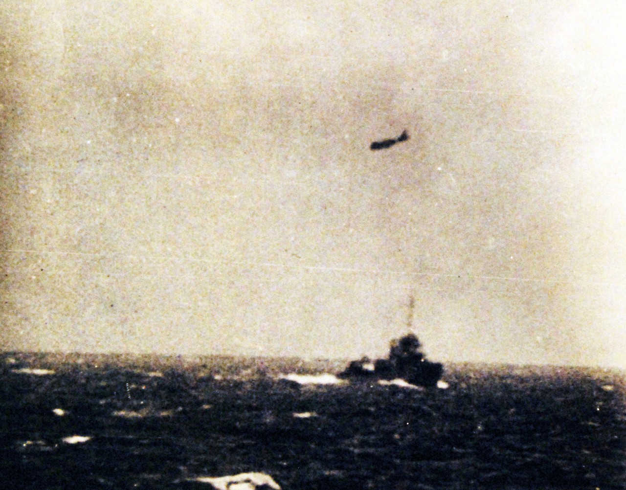 80-G-16639:   Battle of the Coral Sea, May 1942.  A Japanese plane passes over a U.S. destroyer during attacks on the U.S. aircraft carriers, late in the morning of 8 May 1942.  (4/10/2014).