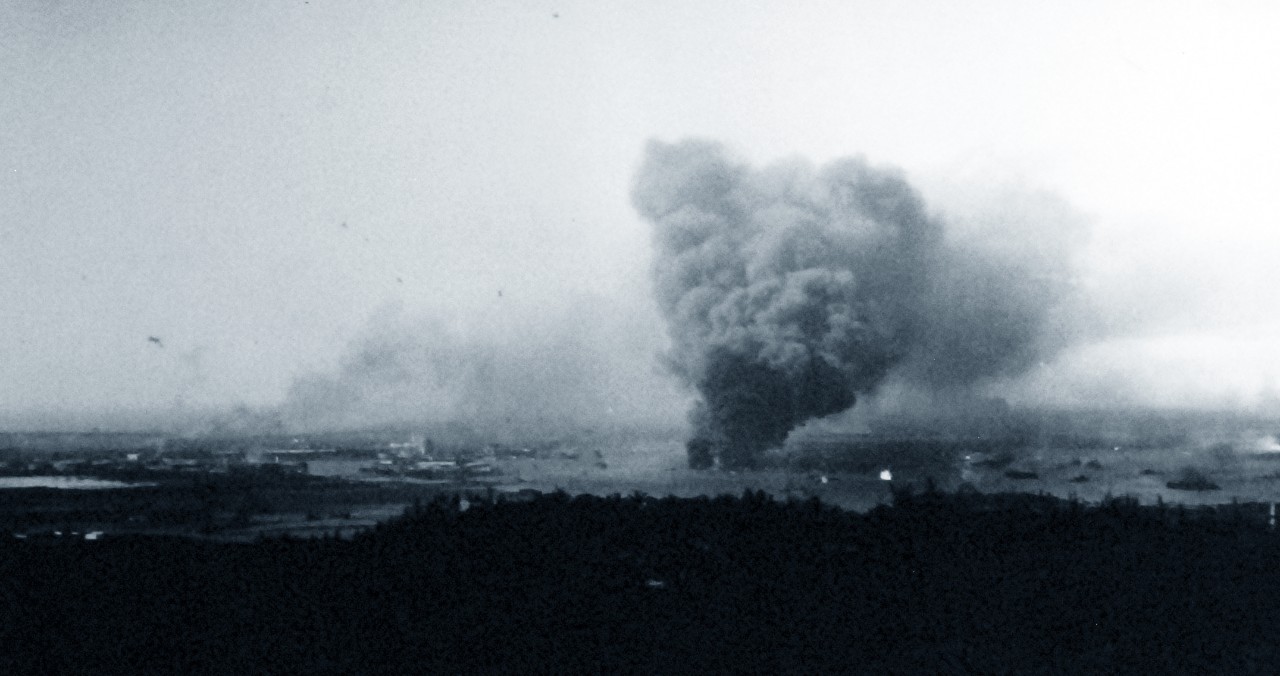 <p>80-G-32789: Japanese Attack on Pearl Harbor, December 7, 1941. Panorama view of Pearl Harbor, during the Japanese raid, with anti-aircraft shell bursts overhead. The photograph looks southwesterly from the hills behind the harbor. Large column of smoke in lower right center is from the burning USS Arizona (BB-39). Smoke somewhat further to the left is from the destroyers Shaw (DD-373), Cassin (DD-372) and Downes (DD-375), in drydocks at the Pearl Harbor Navy Yard. In the series, of which, Photo # 80-G-32792 picture data, is from.&nbsp;</p>
