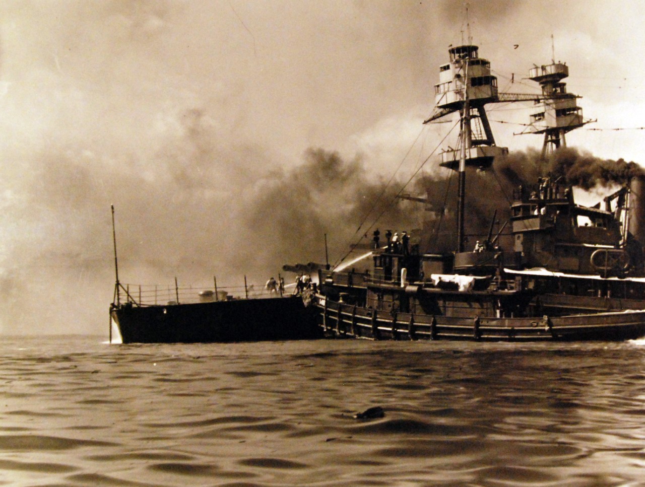 80-G-32743:   Japanese Attack on Pearl Harbor, December 7, 1941.   USS Hoga (YT 146) assisting USS Nevada (BB 36). Official U.S. Navy photograph, now in the collections of the National Archives.  (9/9/2015).