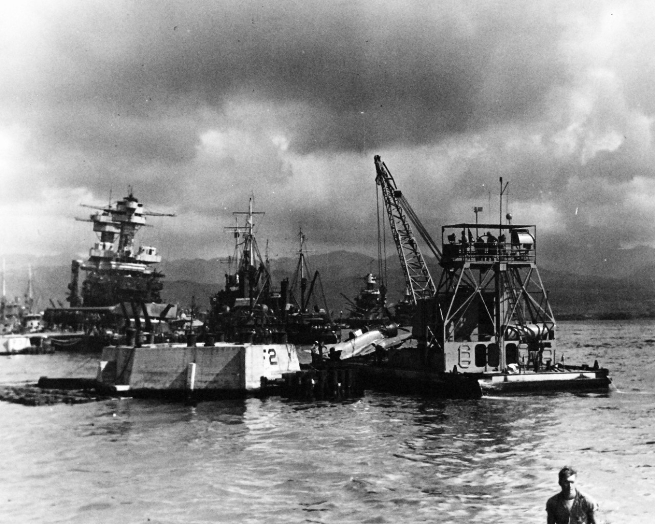 80-G-32440:  Japanese Attack on Pearl Harbor, December 7, 1941.  Salvaging Japanese Navy Type 99 Carrier Bombers (Vals) from the water at Pearl Harbor. Official U.S. Navy photograph, now in the collections of the National Archives.   (9/15/15).