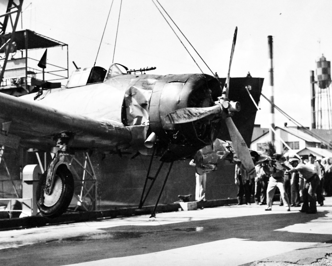 80-G-33016:   Japanese Attack on Pearl Harbor Attack, 7 December 1941.  Japanese Navy Type 99 Carrier Bomber, an Aichi D3A “VAL”,  shot down during the attack, being lifted for transportation.   U.S. Navy photograph, now in the collections of the National Archives.  (9/13/2013).
