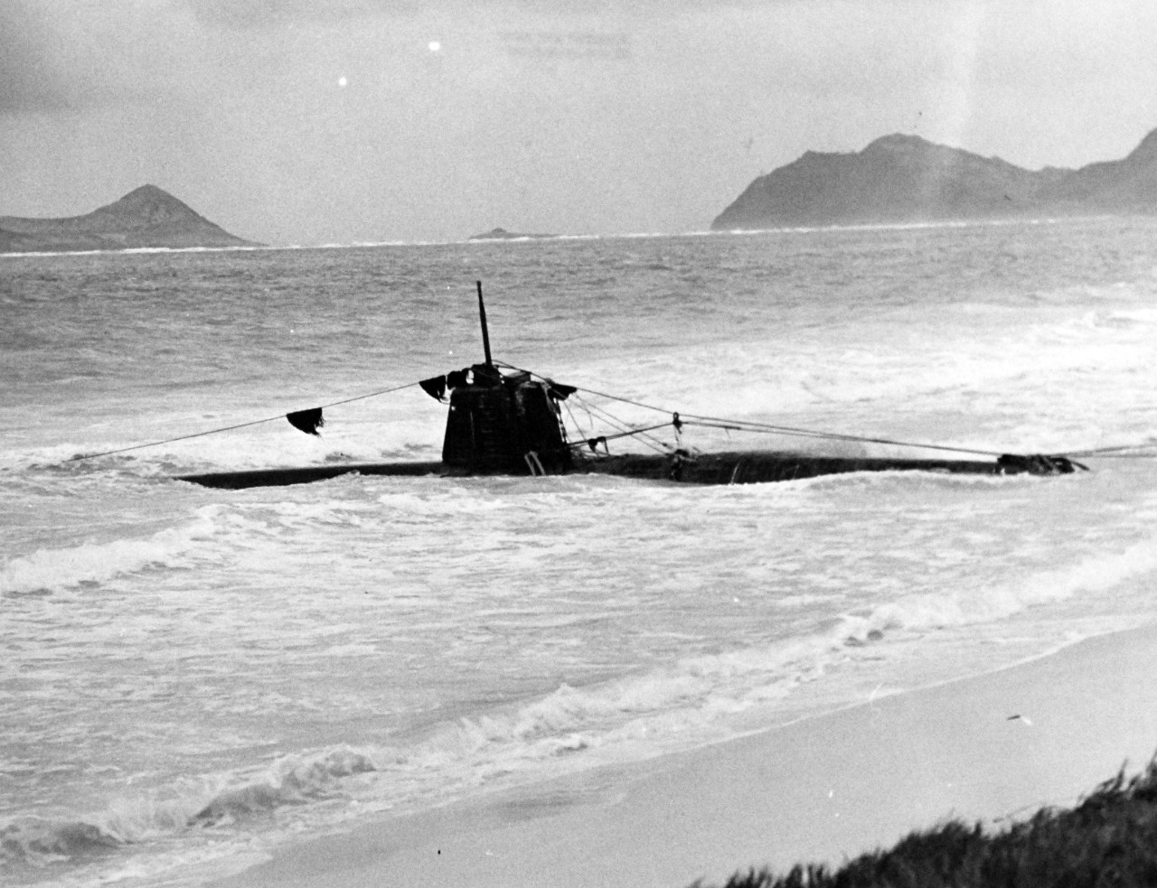 80-G-32680:   Pearl Harbor Attack, December 7, 1941.    HA-19.  (Japanese "Type A" midget submarine).  Beached in eastern Oahu, after it unsuccessfully attempted to enter Pearl Harbor during the attack.  The photograph was taken on or shortly after 8 December 1941. Official U.S. Navy photograph, now in the collections of the National Archives.  (7/2/2014).