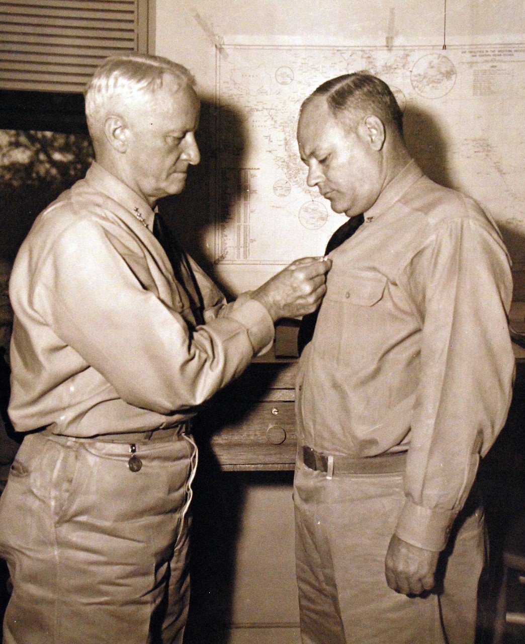 80-G-207864:   Admiral Chester W. Nimitz, USN, Commander-in-Chief of the U.S. Pacific Fleet, presented the Legion of Merit to Captain James M. Steele, USN, on January 8, 1944 at Pearl Harbor, Hawaii, for exceptionally meritorious conduct in performance of outstanding service to the Government of the United States as Salvage Superintendent following the Japanese Attack on Pearl Harbor, Hawaii, December 7, 1941.  Photograph released January 8, 1944.  U.S. Navy Photograph