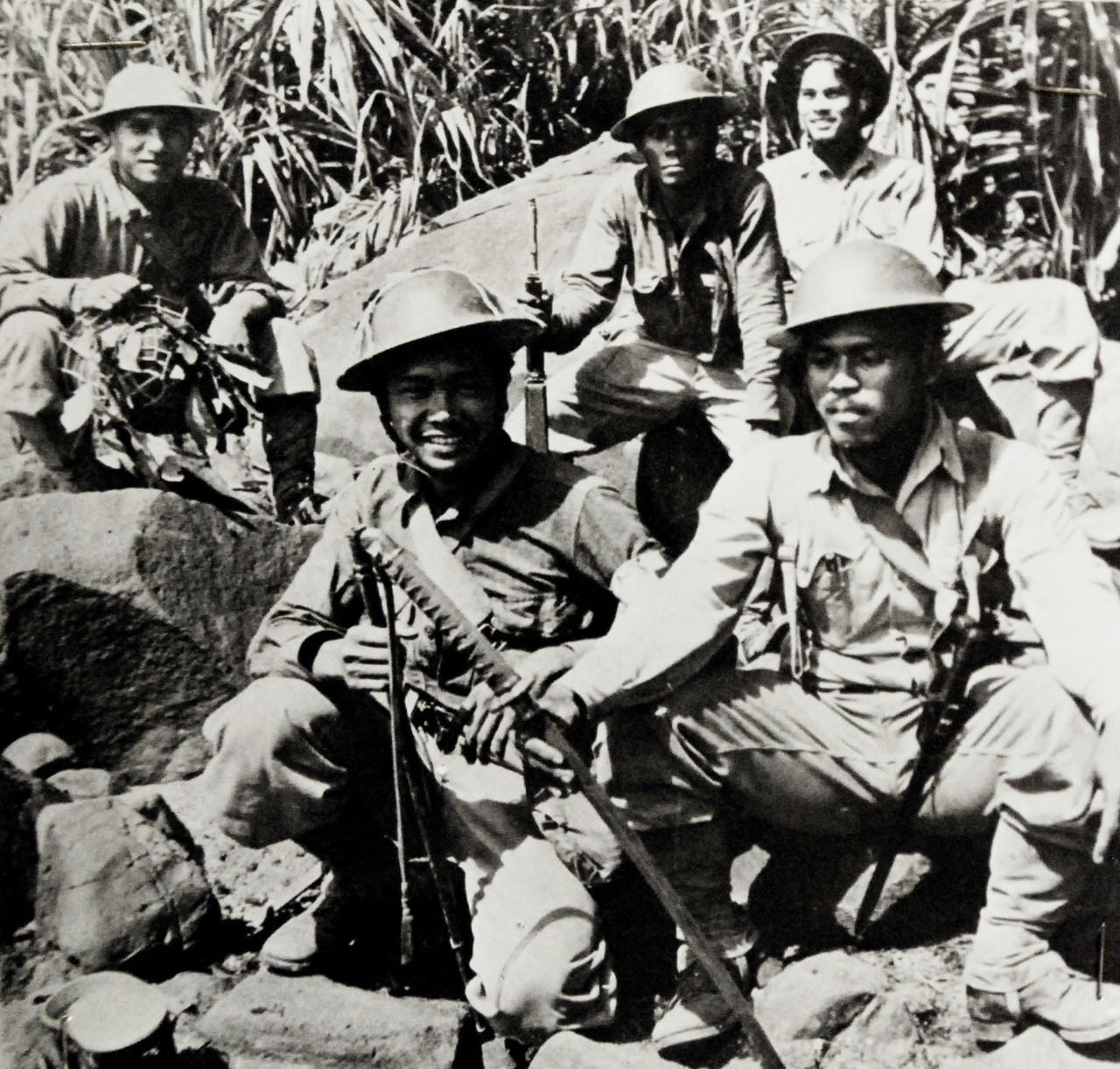 LC-Lot-9432-17: Battle of Bataan, January–April 1942.  These Filipinos Mopped-Up a Japanese Landing Party.  This handful of Filipino Scouts had just mopped up a Japanese landing party when the picture was made on the Philippines’ Bataan Peninsula. One of the Scouts holds a Samurai sword, which was taken from Japanese officer who was slain in the fight.  Courageous men like these were an important factor in enabling the American and Filipino forces to hold Bataan, in the face of tremendous odds, for more than three months – long after it had been written off by outside military experts.  Office of War Information Photograph, 9-15 April 1942.  Original photograph is small.  Courtesy of the Library of Congress.  (2015/12/18).